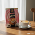 Aik Cheong Latte 12P 300G sachet bag on wooden surface with frothy latte cup
