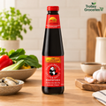 Lee Kum Kee Panda Brand Oyster Sauce bottle on a warm kitchen tabletop