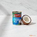 Ayam Coconut Milk 270ml blue tin on marble surface with coconut