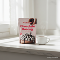 Aik Cheong Chocolate Kosong 12P sachet bag on marble surface with hot chocolate cup