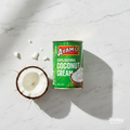 Ayam Coconut Cream 270ml green tin on marble surface with coconut